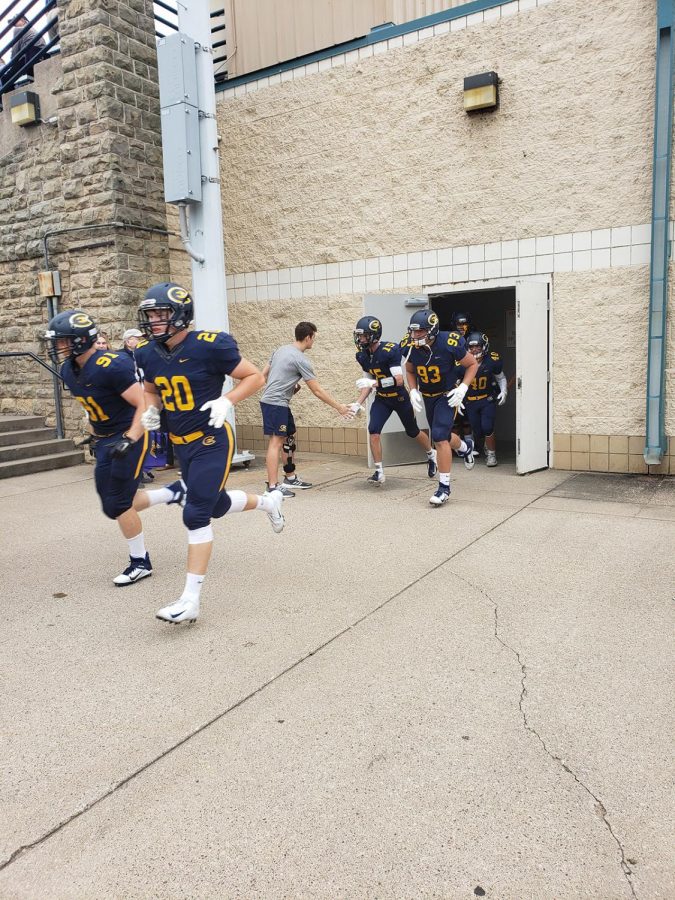 The Blugolds run out to face the Loras Duhawks