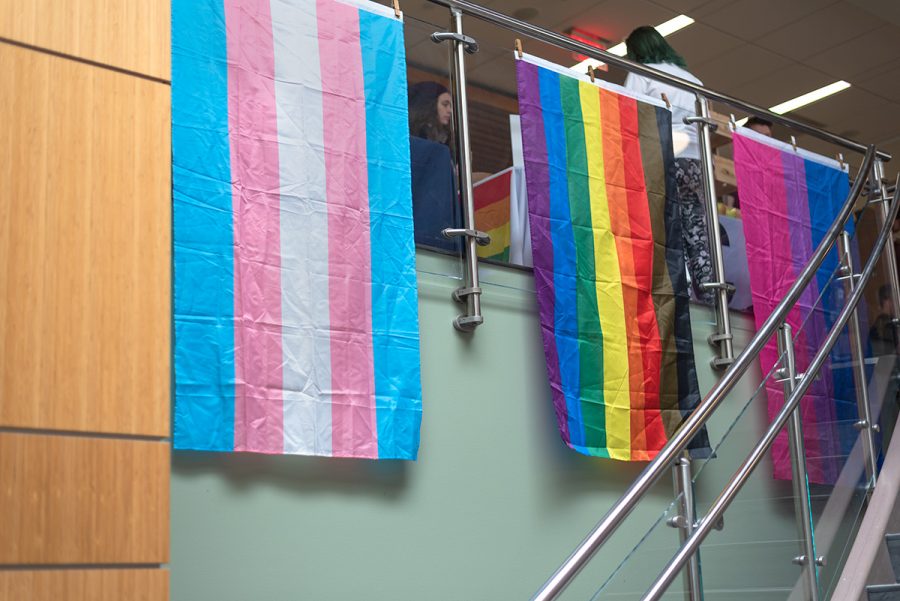 For National Coming Out Day, the Davies Center hangs gender and sexuality flags. 