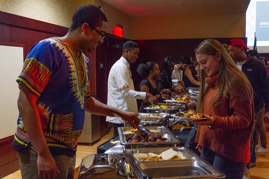 Shawn Smith, a first-year student, served food to attendees at the African Dinner event.