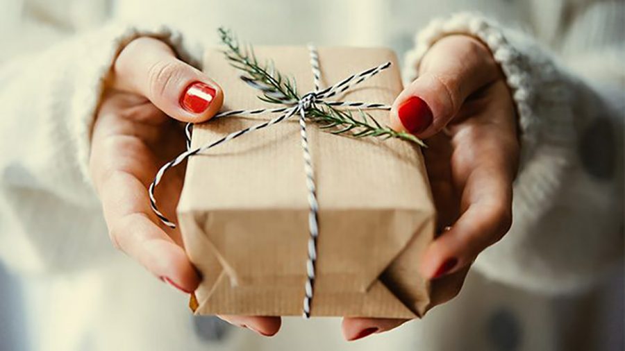 Pictured is a small gift being handed to a loved one.