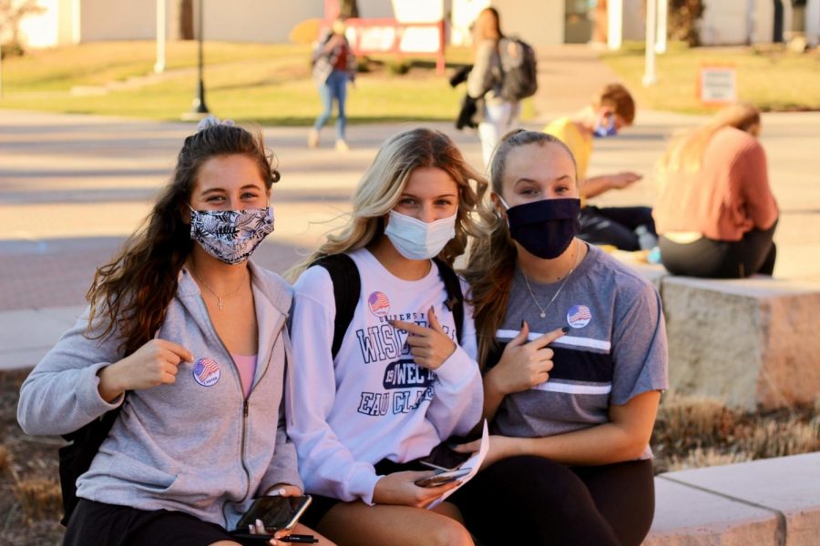 A group of friends proudly shows their “I Voted” stickers.