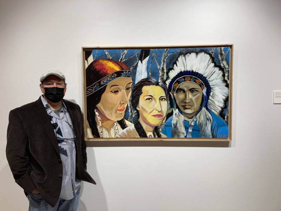  Artist Christopher Sweet poses in front of his paintings featured in the First Nations Contemporary Art exhibit.
