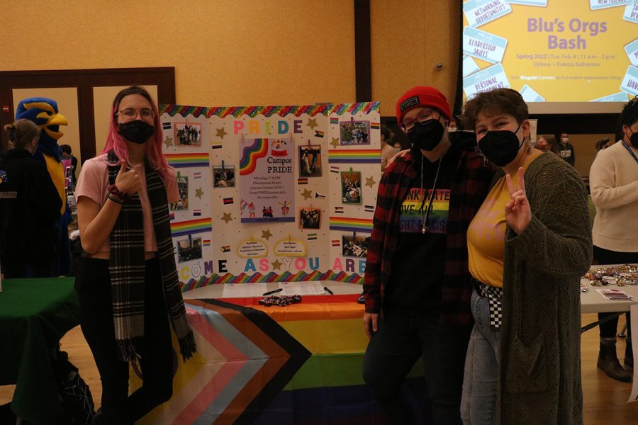 Second year student Lee Quinette, fourth year student Tyler Warwick-Mick and second year student Erin McMichael promote the UW-Eau Claire Campus PRIDE organization. 