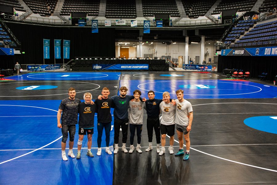 NCAA wrestling qualifiers Tyler Fleetwood, Chase Schmidt, Jared Stricker, Zach Sato, and Jake Drexler with teammates at national tournament.