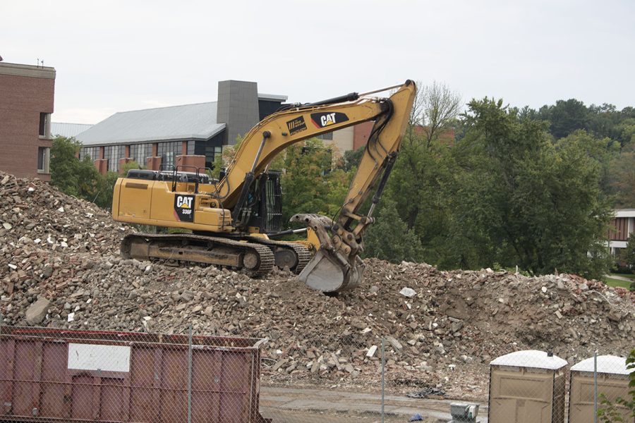 Bulldozer digs through debris of Putnam Hall