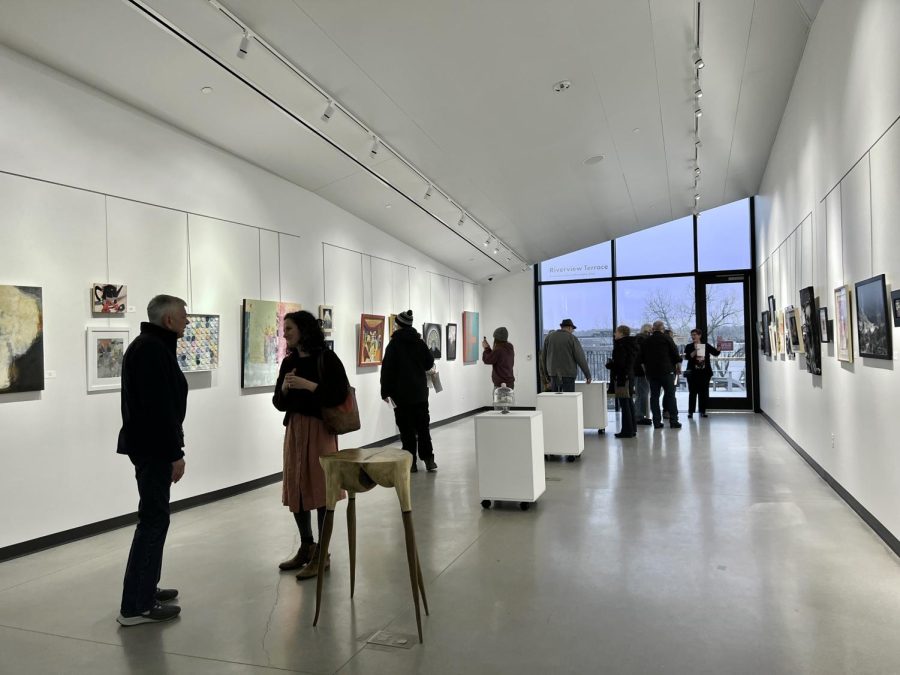 Gallery+attendants+observing+the+art+pieces+after+the+artist+reception.