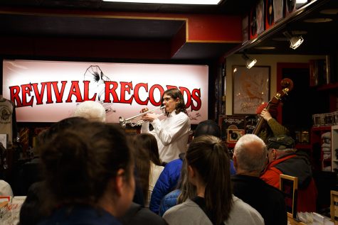 A crowd packs into Revival Records to listen to a high school jazz combo.