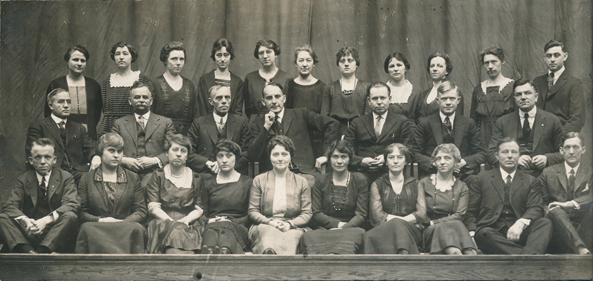 President Harvey Schofield (middle row, center) and The Spectator advisers W.E. Slagg (middle row, third from right) and A.L. Murray (bottom row, far right) in a 1920 faculty photo from The Periscope.