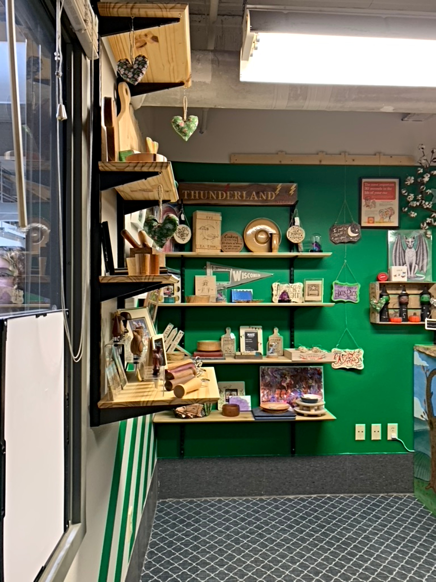 A pop-up wood carving shop shows some of the knick-knacks that can be purchased to help support their business.