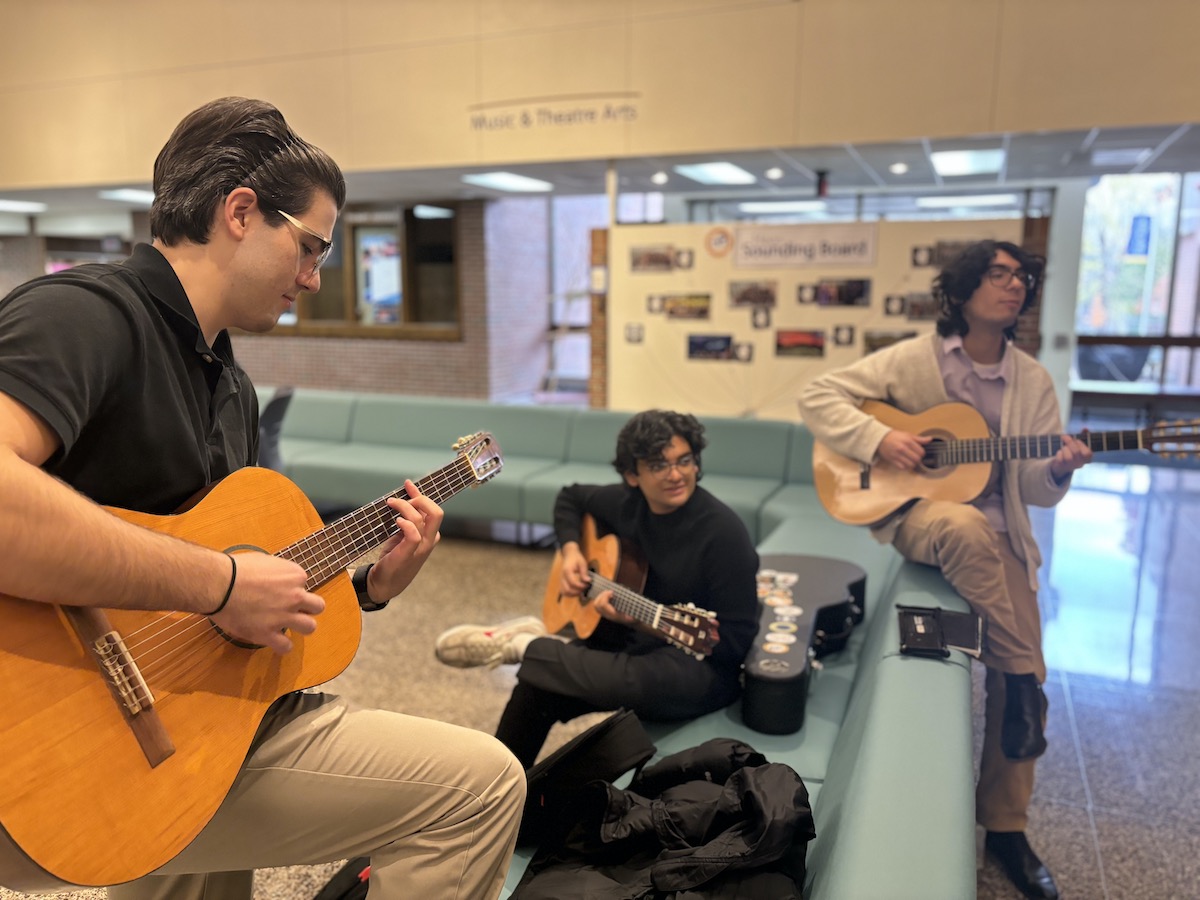 From left to right, Connor Simon, Jai Chaturvedi, and Derek Braend, playing their guitars in Haas Lobby