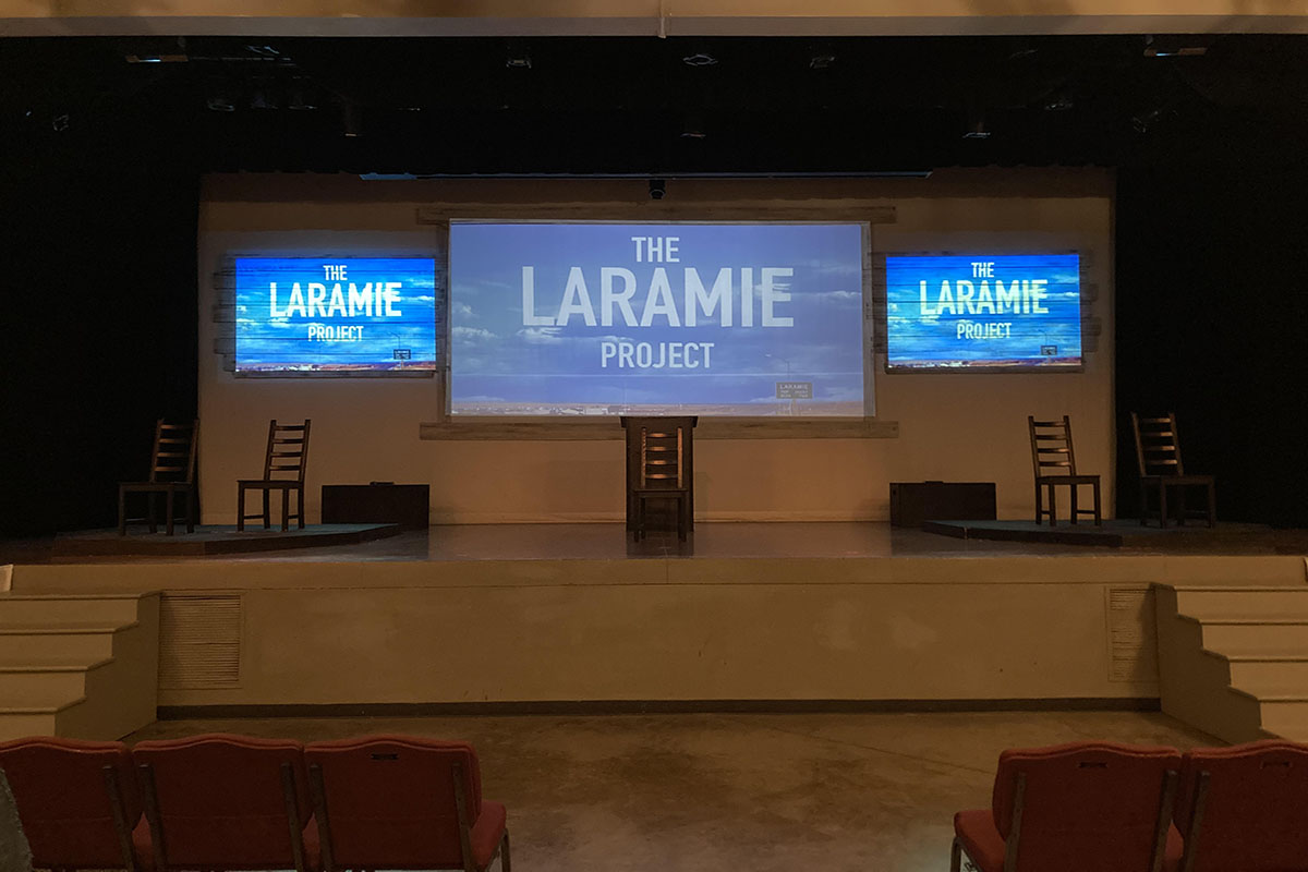 The cast of The Laramie Project uses projection screens but minimal sets to tell their story.