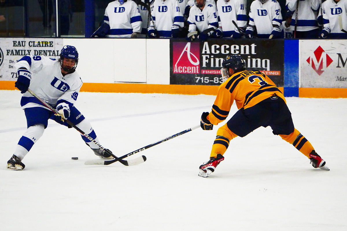 Graduate student Tyler Love working to get the puck past his opponent.
