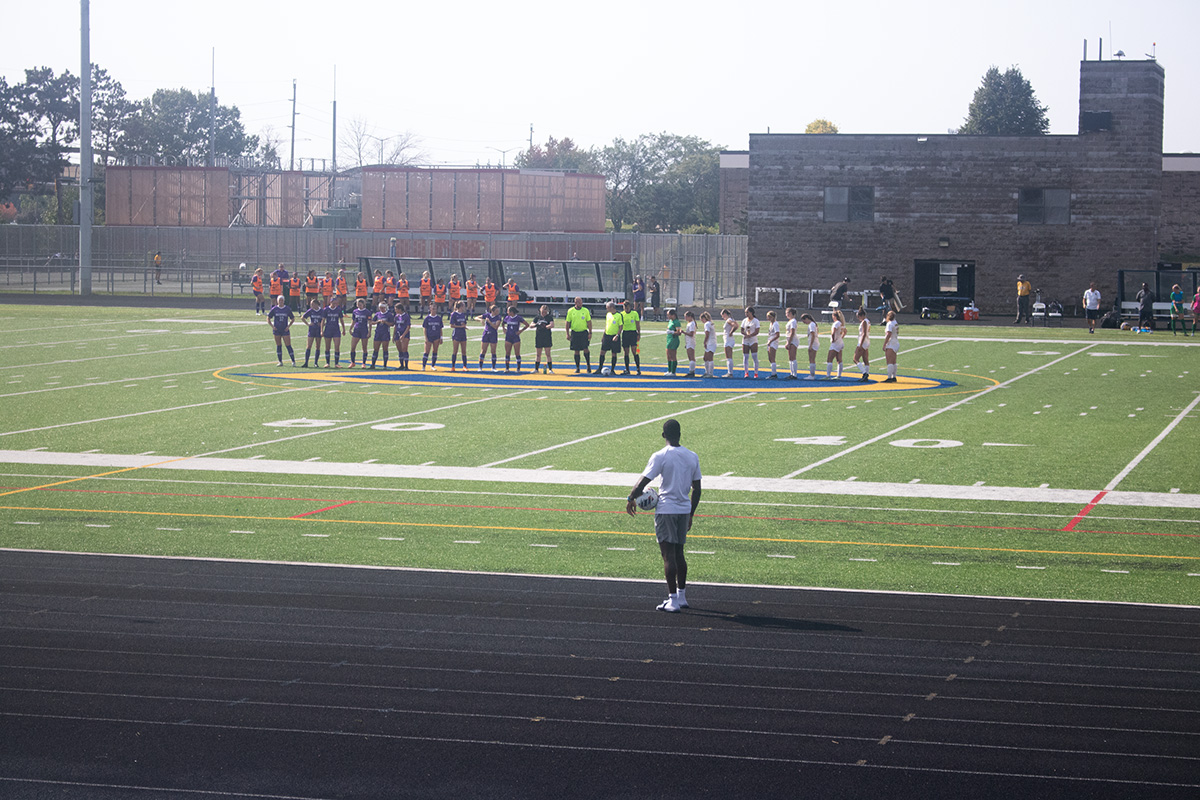 The UWEC and UWW women’s soccer teams begin to line up for the Star Spangled Banner
