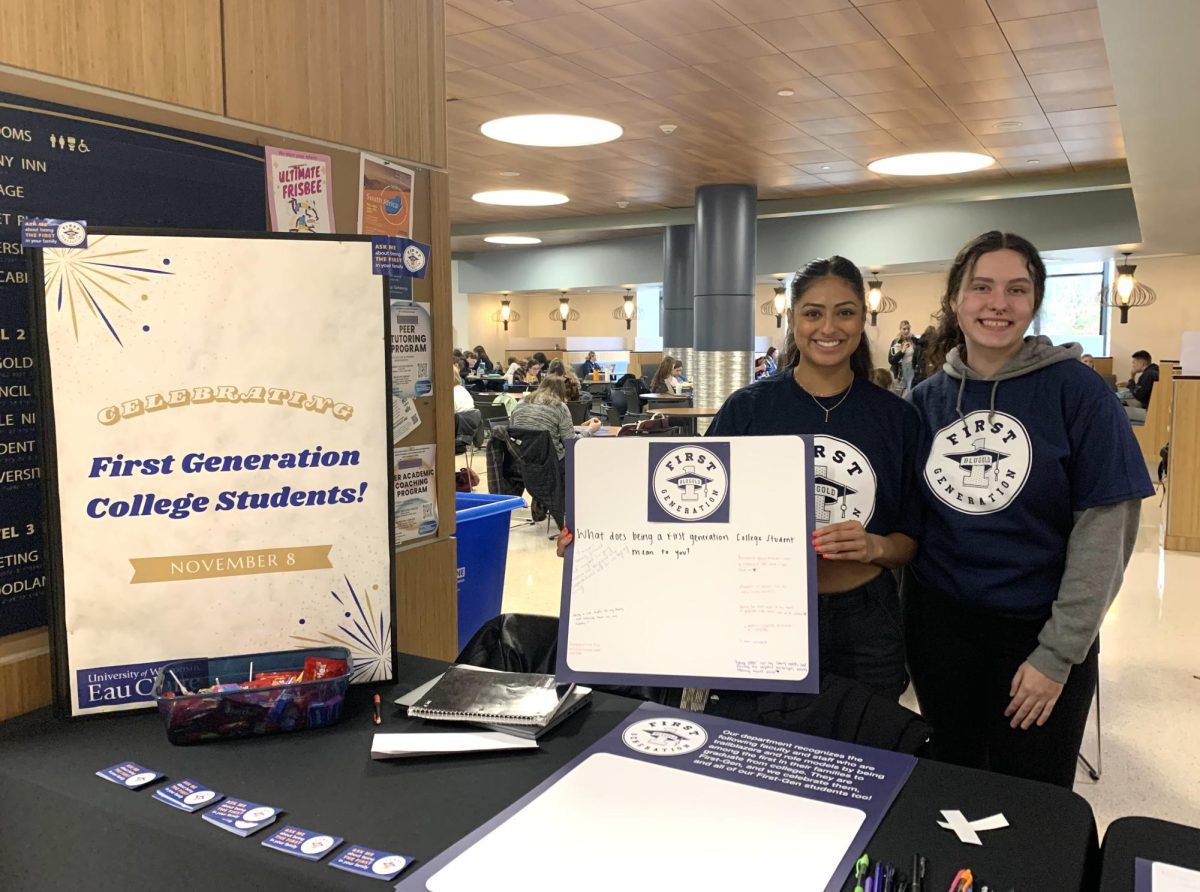 Students involved in National First-Generation Student Day set up a table in Davies Center to hand out t-shirts and stickers.