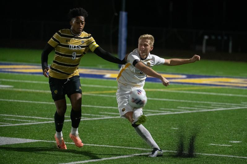 Fourth-year defender David Lynch kicks the ball away under pressure. (Photo by Shane Opatz, used with permission from Blugold Athletics)