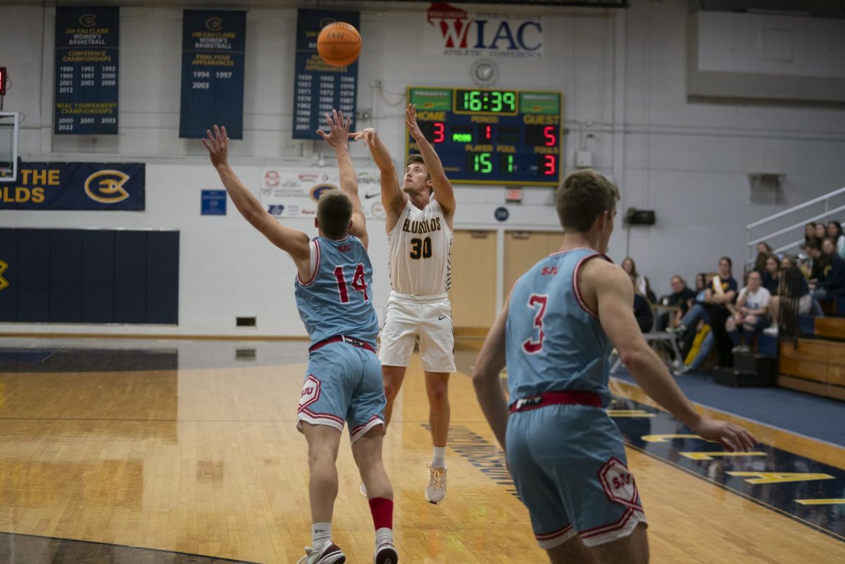 Michael Casper attempts a three-point shot. (Photo by Bill Hoepner, used with permission from Blugold Athletics)