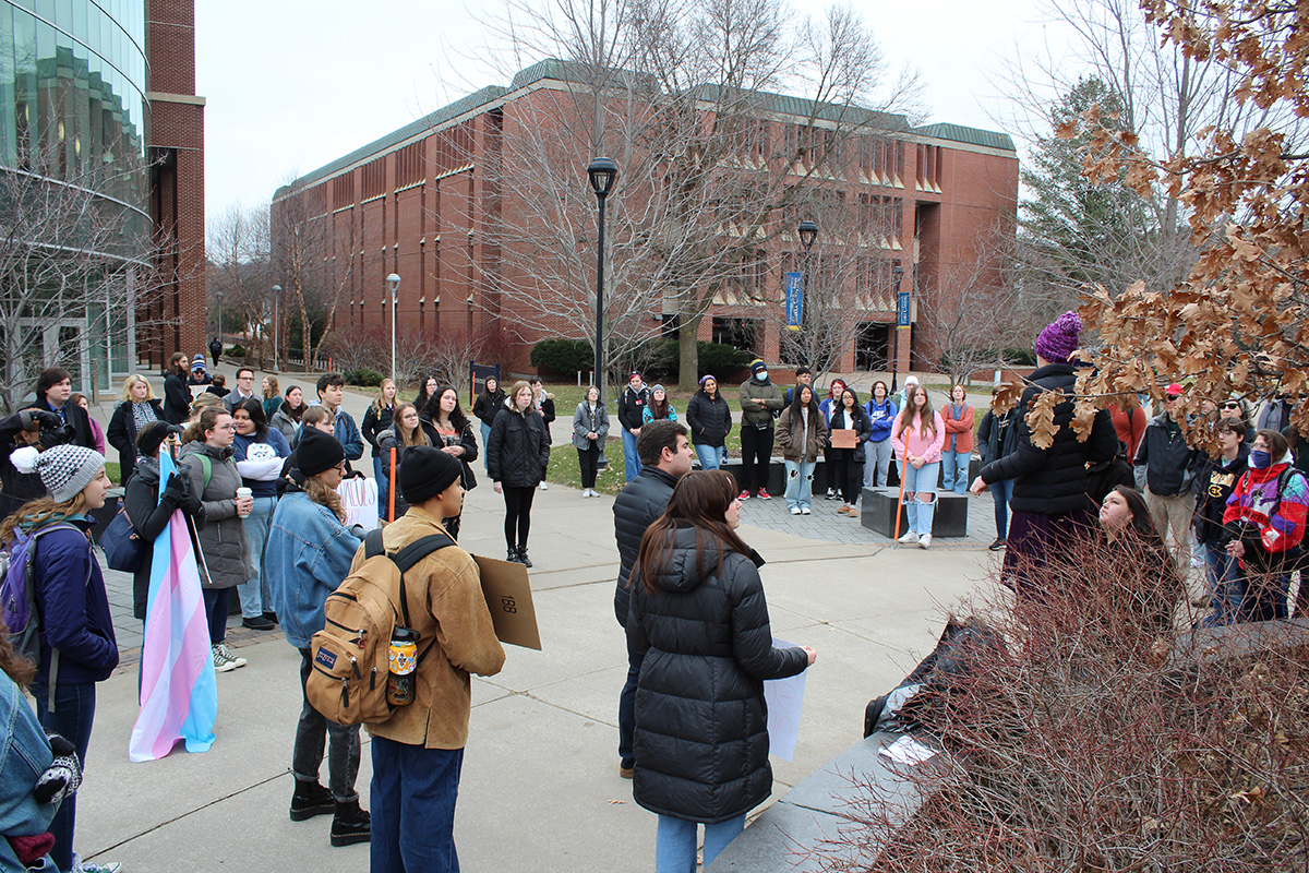 Students, faculty and community members held signs and spoke in front of Centennial Hall.