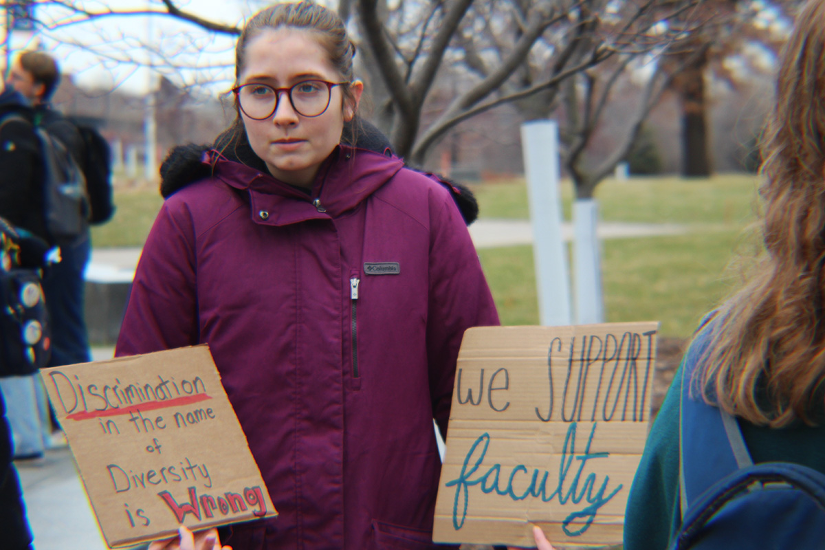 A student protesting against DEI held a sign saying, Discrimination in the name of diversity is wrong.