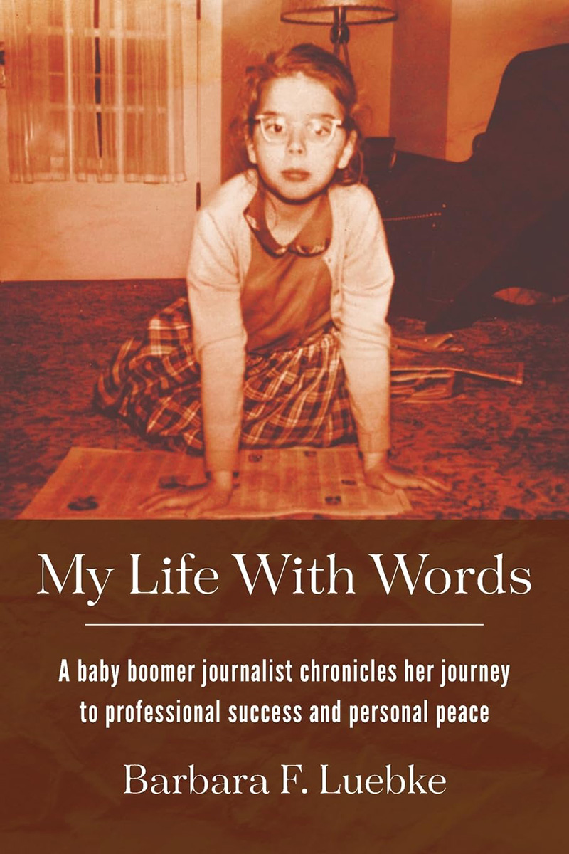The cover of “My Life With Words” features a picture of a younger Luebke reading a newspaper
