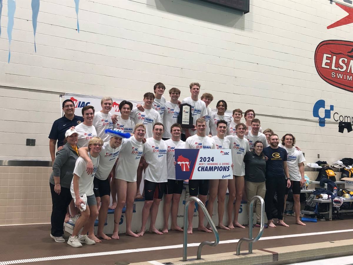 The mens swim team celebrates after their WIAC win. (Photo by Matt Stanek from WIAC Sports Information used with permission.)