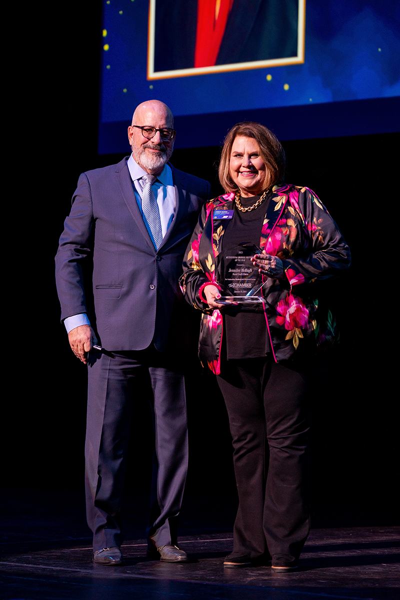 Dave Minor, Eau Claire Area Chamber of Commerce President/CEO, and Jennifer McHugh as she accepts her award. (Photo used with permission from the Eau Claire Area Chamber of Commerce)