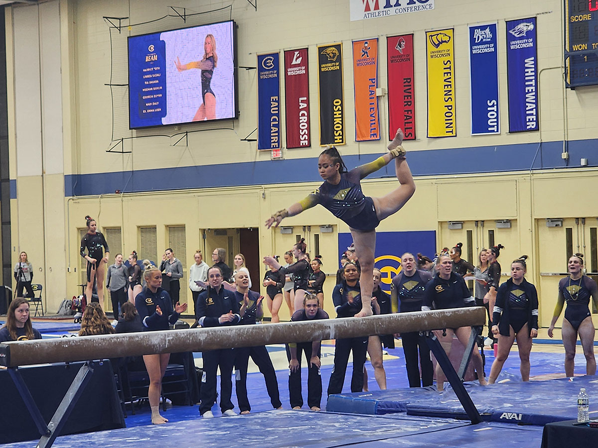 Fourth-year Tia Ravara performing on the balance beam.