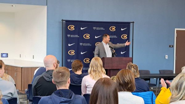 Director of Athletics Jason Verdugo standing in front of coaches, athletes, sponsors and community members to kickstart Giving Week 2024.