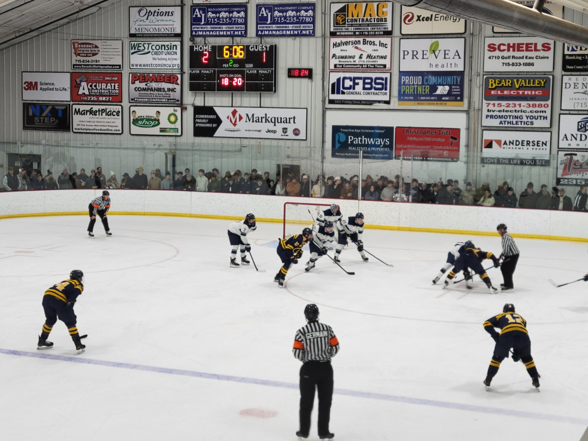 By the Blue Devils' goal, both teams fight for the puck off a faceoff. (Photo used with permission from Pete Knutson)